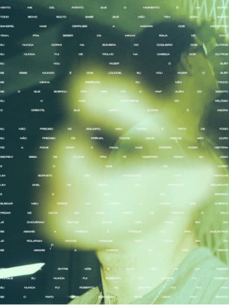 A blurred green-toned face overlaid with rows of small white text.